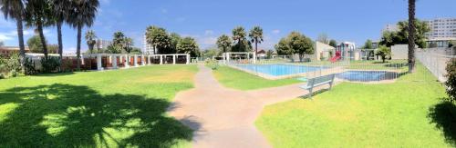 a large yard with a swimming pool and a park at Departamento La Serena Avenida Del Mar in La Serena