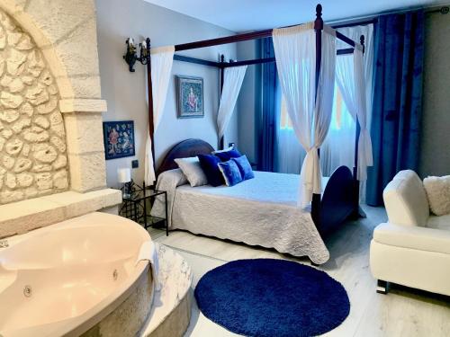 a bedroom with a bed and a tub in a room at Hotel Castillo Bonavía in Pedrola