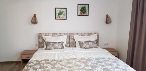 a bedroom with a large bed with pillows at Aparthotel Olympus Plaza - SPA & Indoor Pool in Kranevo