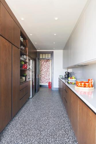 a kitchen with wooden cabinets and a counter top at Root Redrock Yalıkavak in Yalıkavak