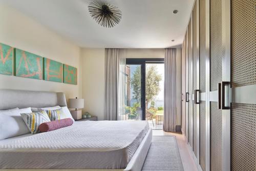 a bedroom with a bed and a large window at Root Redrock Yalıkavak in Yalıkavak