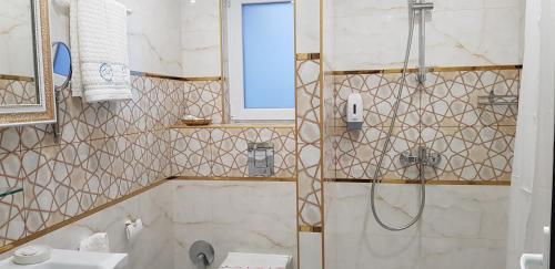 a bathroom with a shower and a sink at Aparthotel Olympus Plaza - SPA & Indoor Pool in Kranevo