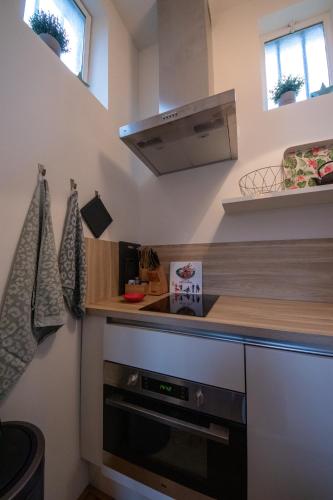 a kitchen with a stove and a counter top at De Cel in Nes