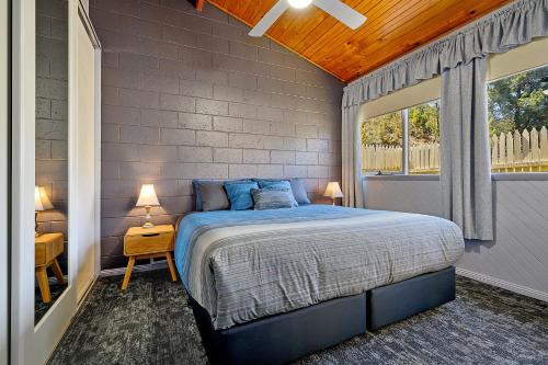 a bedroom with a bed and a large window at Gold Rush Inn in Queenstown