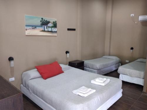 a room with two beds with towels on them at Hotel Segundo Roma in Villa La Paz