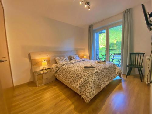 a bedroom with a bed and a large window at Ribasol 422, apartamento hasta 6 personas, Arinsal in Arinsal