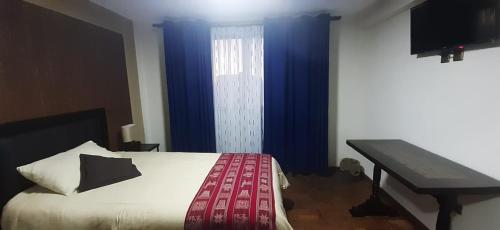 
A bed or beds in a room at Hostal Jerian
