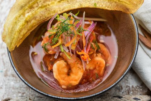 a bowl of food with shrimp and vegetables in it at Oz Hotel Luxury in Cartagena de Indias