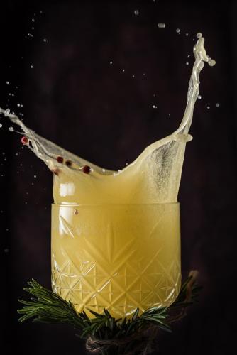 a drink splashing in a glass with christmas decorations at Oz Hotel Luxury in Cartagena de Indias