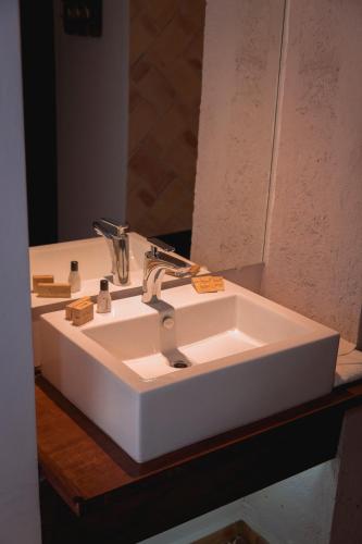 a white sink in a bathroom with a mirror at Casa Eva Hotel Boutique & Spa in Cholula