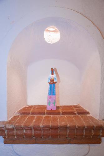 a toy lighthouse sitting on top of a brick shelf at Casa Eva Hotel Boutique & Spa in Cholula