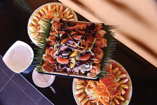 two plates of food sitting on top of a table at Timor Plaza Hotel & Apartments in Dili