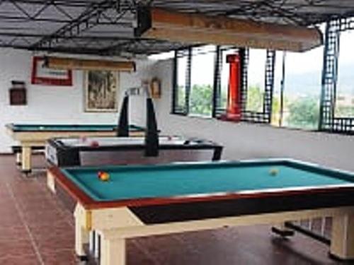 two pool tables in a room with windows at HOTEL ANAPOIMA PLAZA IN in Anapoima