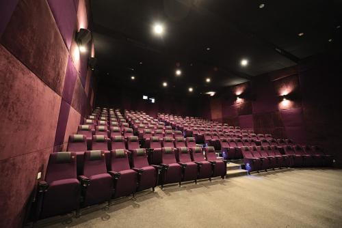 an empty auditorium with purple chairs in a theatre at Timor Plaza Hotel & Apartments in Dili