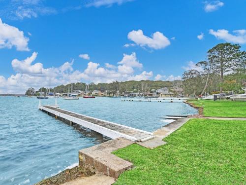 a dock in the middle of a body of water at The Boat House Absolute Waterfront and Jetty in Morisset East