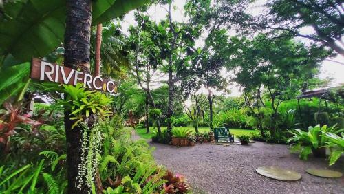 a garden with a sign in the middle of it at River CoCo @ Amphawa in Samut Songkhram