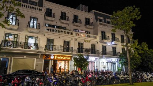 a building with a bunch of motorcycles parked in front of it at NEW CITY HOTEL in Tây Ninh