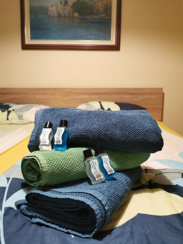 a pile of towels sitting on top of a bed at Lukanov Apartments & Guest Rooms in Ohrid