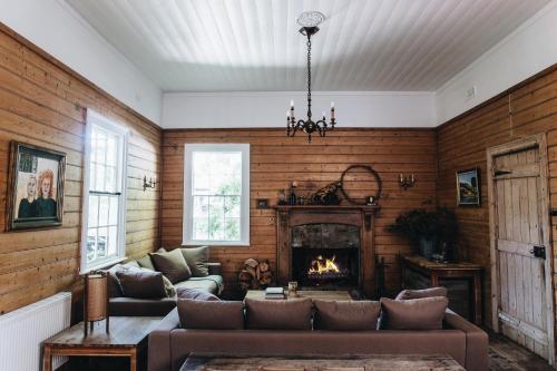a living room with a couch and a fireplace at The Main House @ Poets Lodge in Daylesford