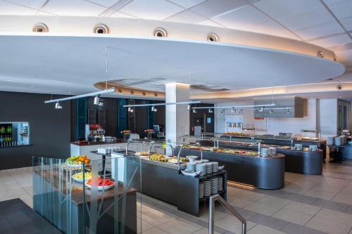 a restaurant with a buffet line with food on display at Mayfair Gardens in Paphos City