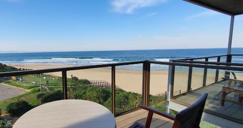 a balcony with a view of the beach at On the Beach Guesthouse Jeffreys Bay in Jeffreys Bay