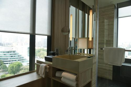a bathroom with a sink and a large window at PARKROYAL COLLECTION Pickering, Singapore in Singapore