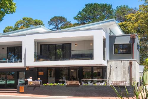 a large white house with people sitting on the porch at The Tipsy Grape Downtown, Margaret River in Margaret River Town