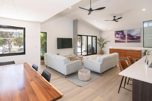 a living room with a couch and a table at The Tipsy Grape Downtown, Margaret River in Margaret River Town
