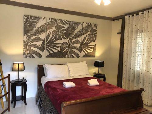 a bedroom with a bed with two towels on it at The Duyan House at Sinagtala Resort in Orani