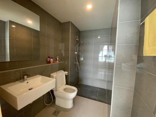 a bathroom with a toilet and a sink and a shower at NASA Family Suite at Imperium Residence in Kuantan