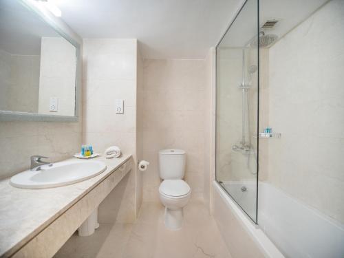 ein Bad mit einem WC, einem Waschbecken und einer Dusche in der Unterkunft Avlida Hotel in Paphos City