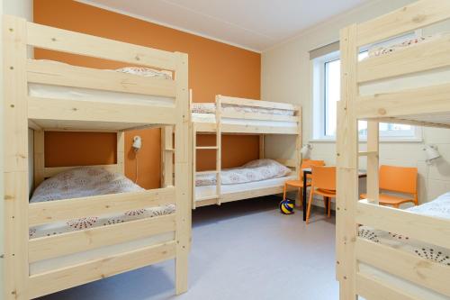 a room with three bunk beds and a window at Märjamaa spordihoone in Märjamaa