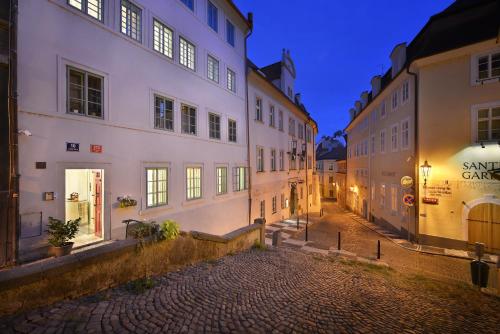 an alley in an old town at night at Nobles Apartments in Prague