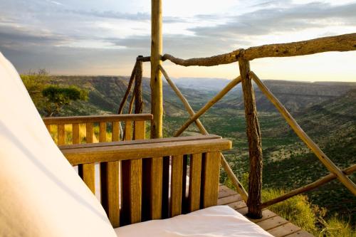 a porch with a hammock and a view at Grootberg Lodge in Damaraland