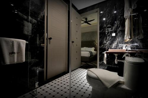 a black bathroom with a toilet and a sink at 1969 Business Suites @ Ipoh Garden in Ipoh