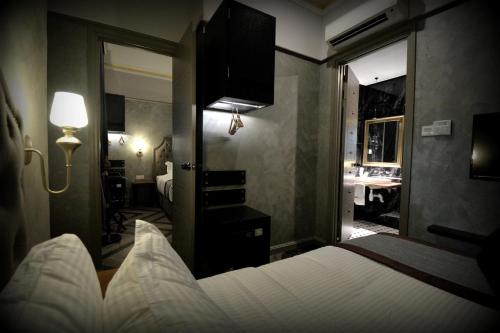a hotel room with a bed and a mirror at 1969 Business Suites @ Ipoh Garden in Ipoh