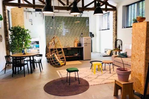 a room with a kitchen and a table and chairs at De slaaploods in Kerkrade
