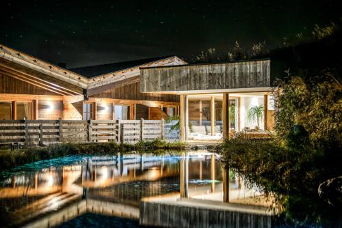 a house with a pool in front of it at night at Chalet Stern in Vipiteno