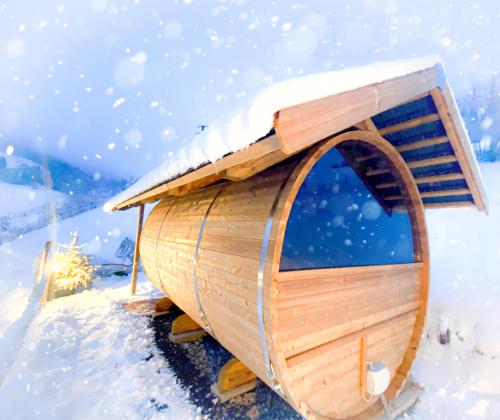 a wooden dog house covered in snow at Lieblingsort - Cosy Black Forest Chalets in Neuenweg