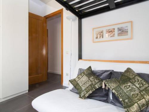 a room with a couch with pillows on it at Sunny apartment 3 blocks to the beach in Castelldefels