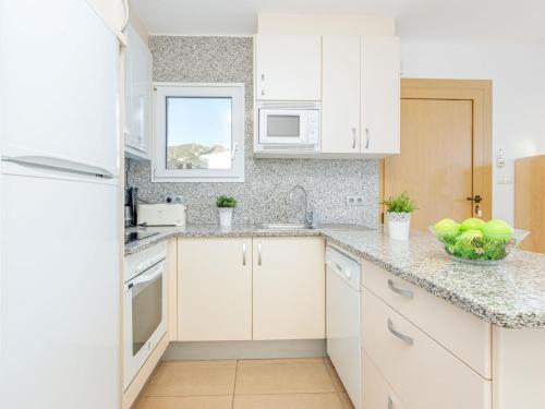 a kitchen with white cabinets and a counter top at Apartment Santa Lucia by Interhome in Montjoys