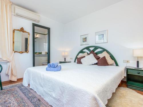 a bedroom with a large white bed and a mirror at Holiday Home acacies by Interhome in Navata