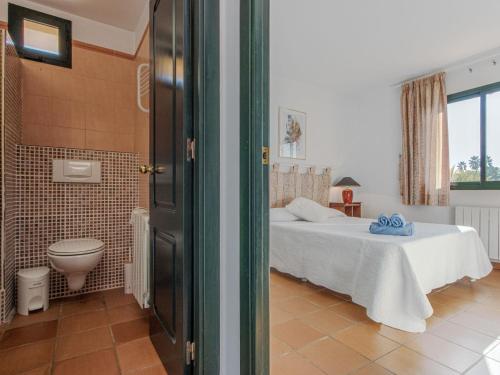 a bedroom with a bed and a toilet in a room at Holiday Home acacies by Interhome in Navata