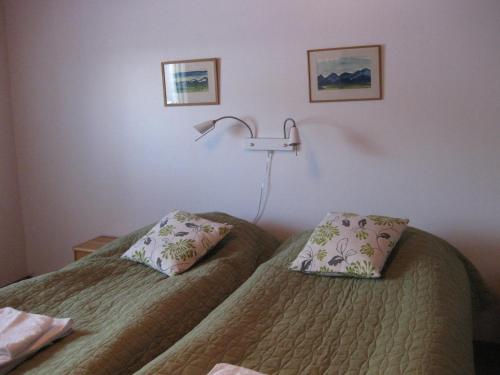 a hotel room with two beds and a lamp at Hotell Samegård in Kiruna