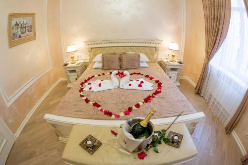 a bedroom with a bed with a heart made out of pillows at Apart-hotel Horowitz in Lviv