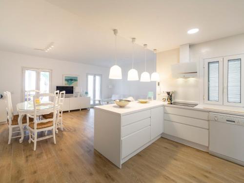 een keuken en eetkamer met witte kasten en een tafel bij Holiday Home Los Frasquitos by Interhome in Vera