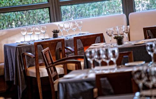 a row of wine glasses on tables in a restaurant at Best Western Plus Hotel Alfa Aeropuerto in Barcelona