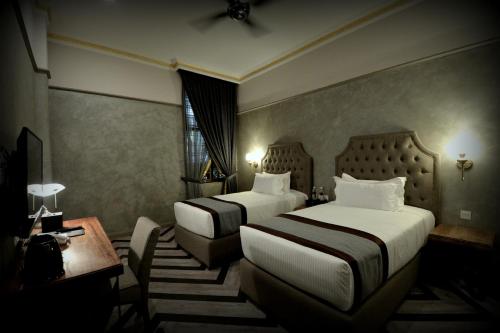 Postel nebo postele na pokoji v ubytování 1969 Business Suites @ Ipoh Garden
