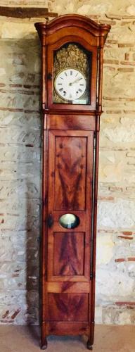 a wooden grandfather clock sitting against a wall at Manoir du Bois Mignon in Le Fleix
