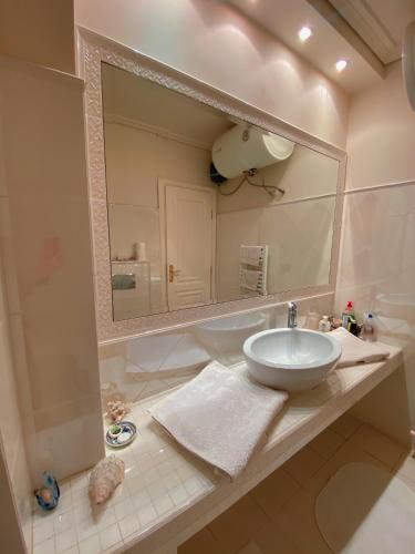 a bathroom with a sink and a large mirror at Pendeli's Luxury in Athens